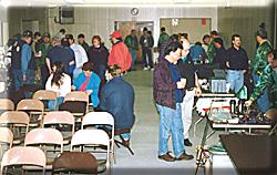 Members gather around tables filled goodies.